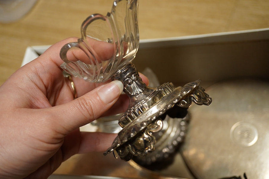 A pair of late 19th/early 20th century French white metal mounted pedestal glass salts, height 87mm, together with a pair of Victorian silver pedestal pepperettes, by Charles Stuart Harris, London, 1884, a silver mounted